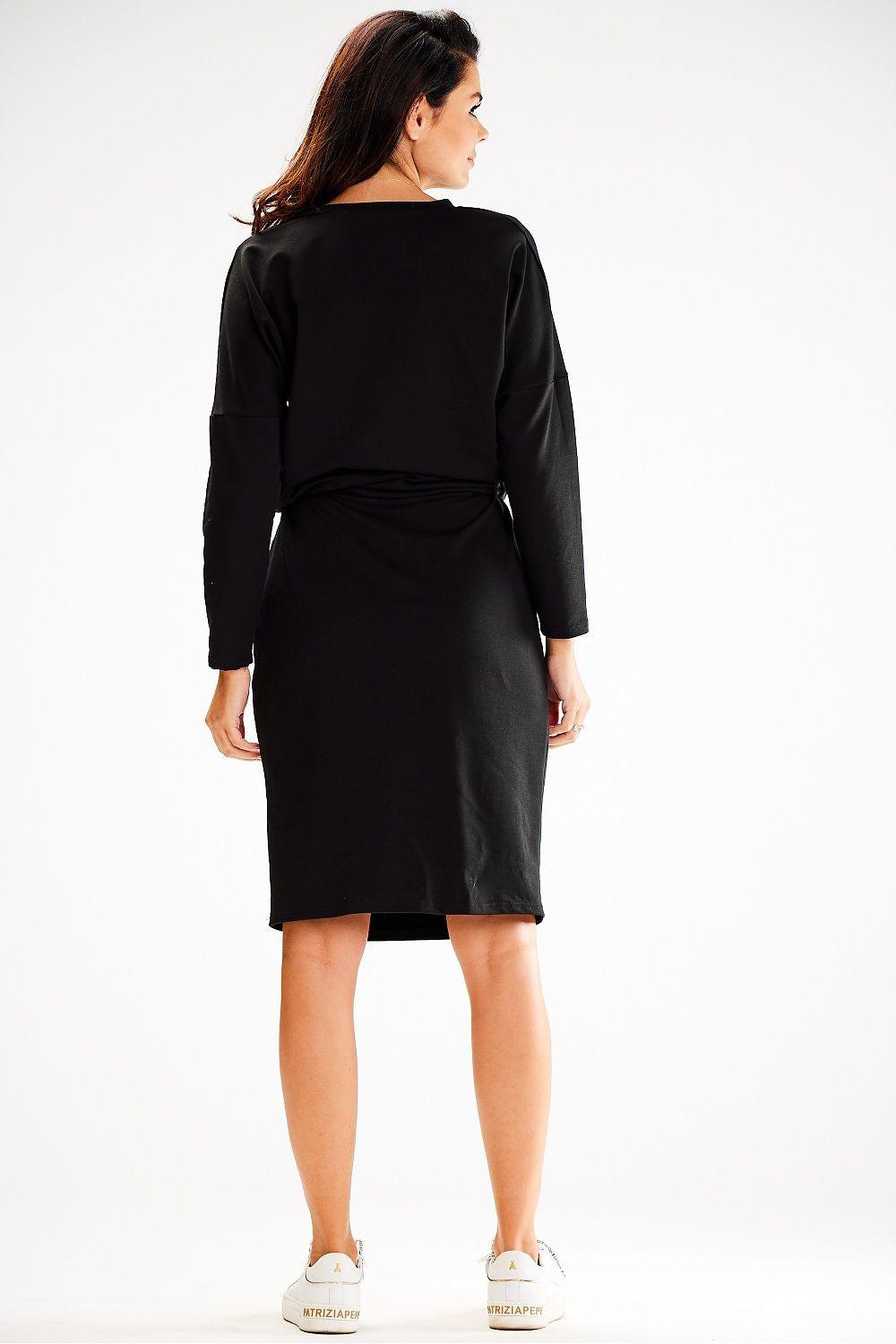 Black daydress rear view with long sleeves and tied waist midi hem