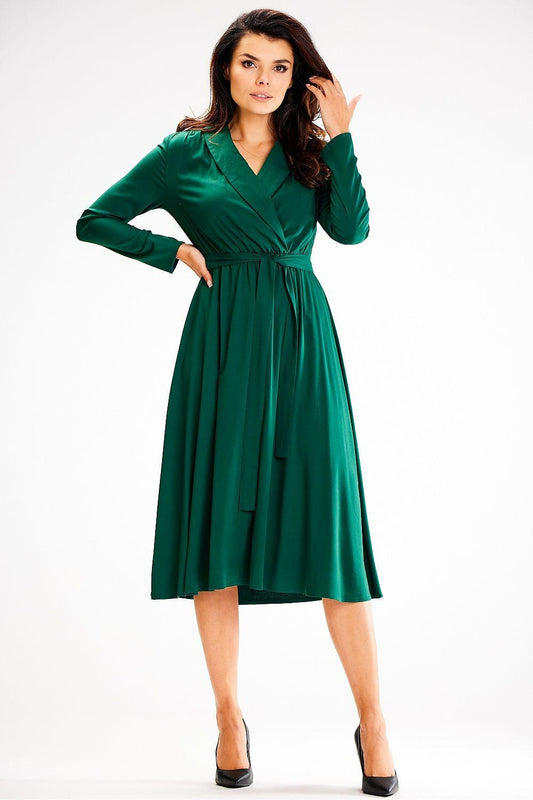 Green daydress with V-neck, long sleeves, gathered waist tie, and midi skirt.
