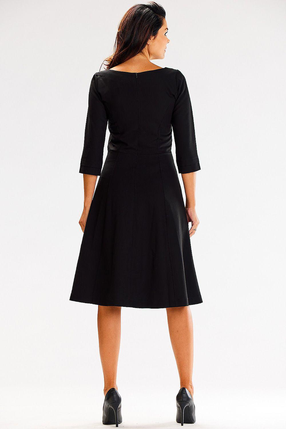 Black daydress back view with round neckline, 3/4 sleeves, and flared midi skirt.
