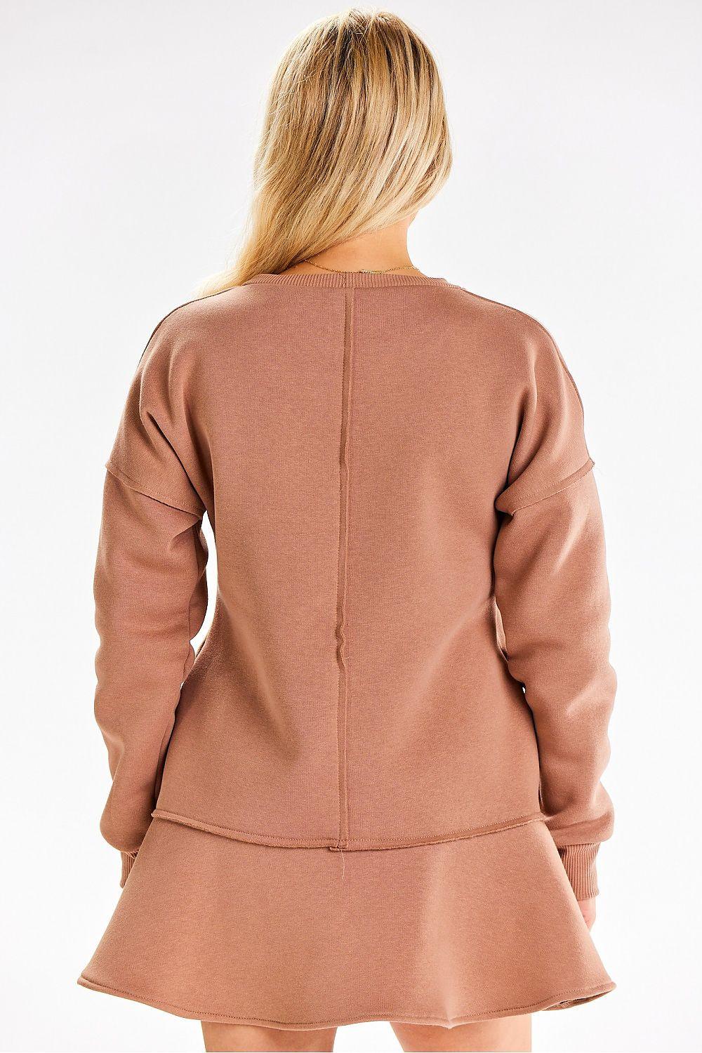 Tan long-sleeve daydress, back view, with ruffled hem and central seam