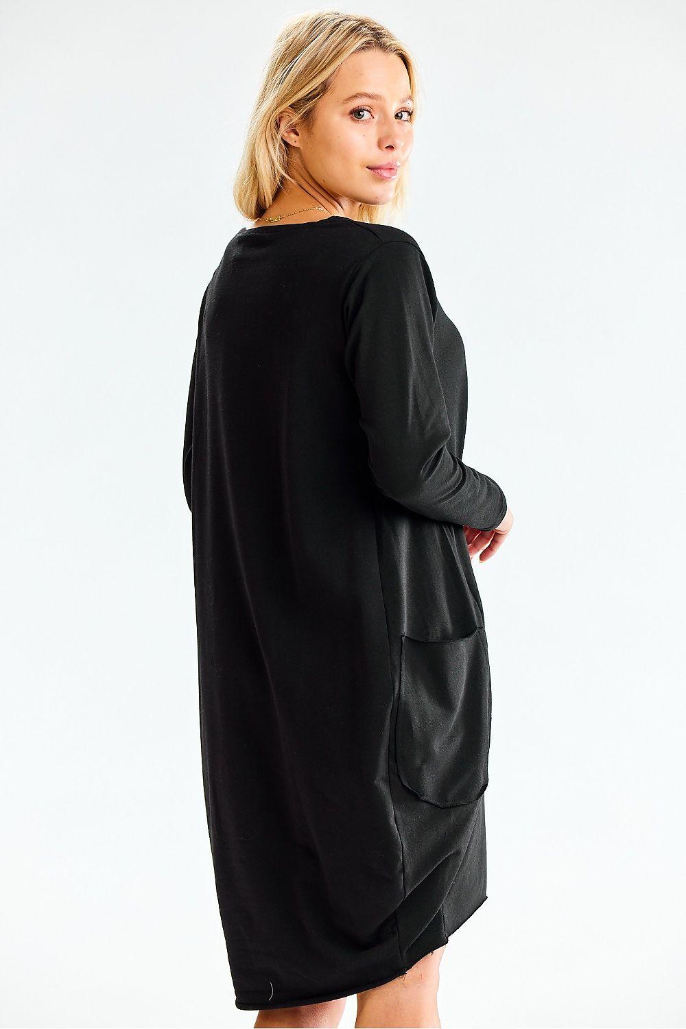Black long-sleeve daydress with round neckline, roomy swing shape, side pockets