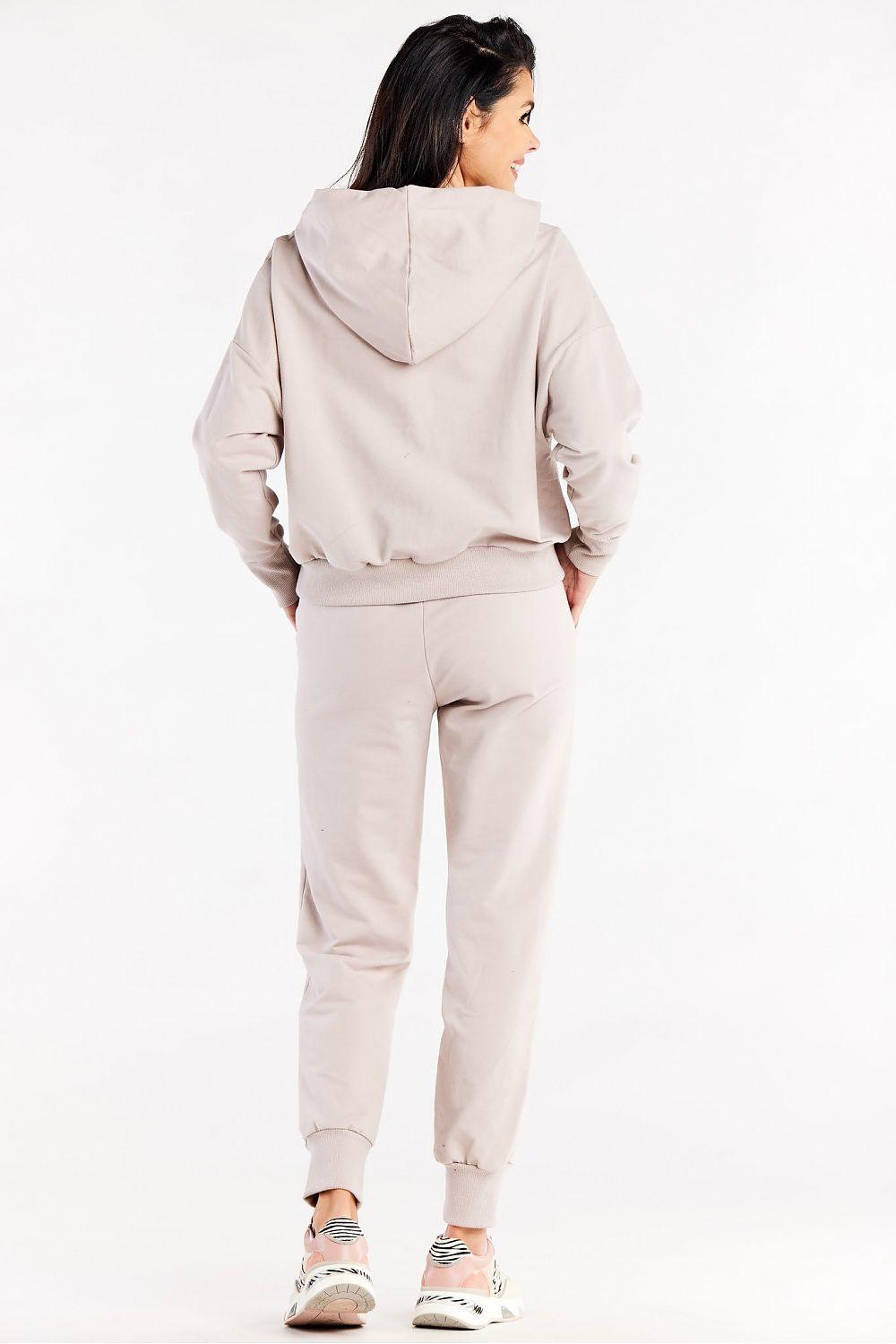Beige jogger trousers with elastic waist and cuffed ankles, rear view