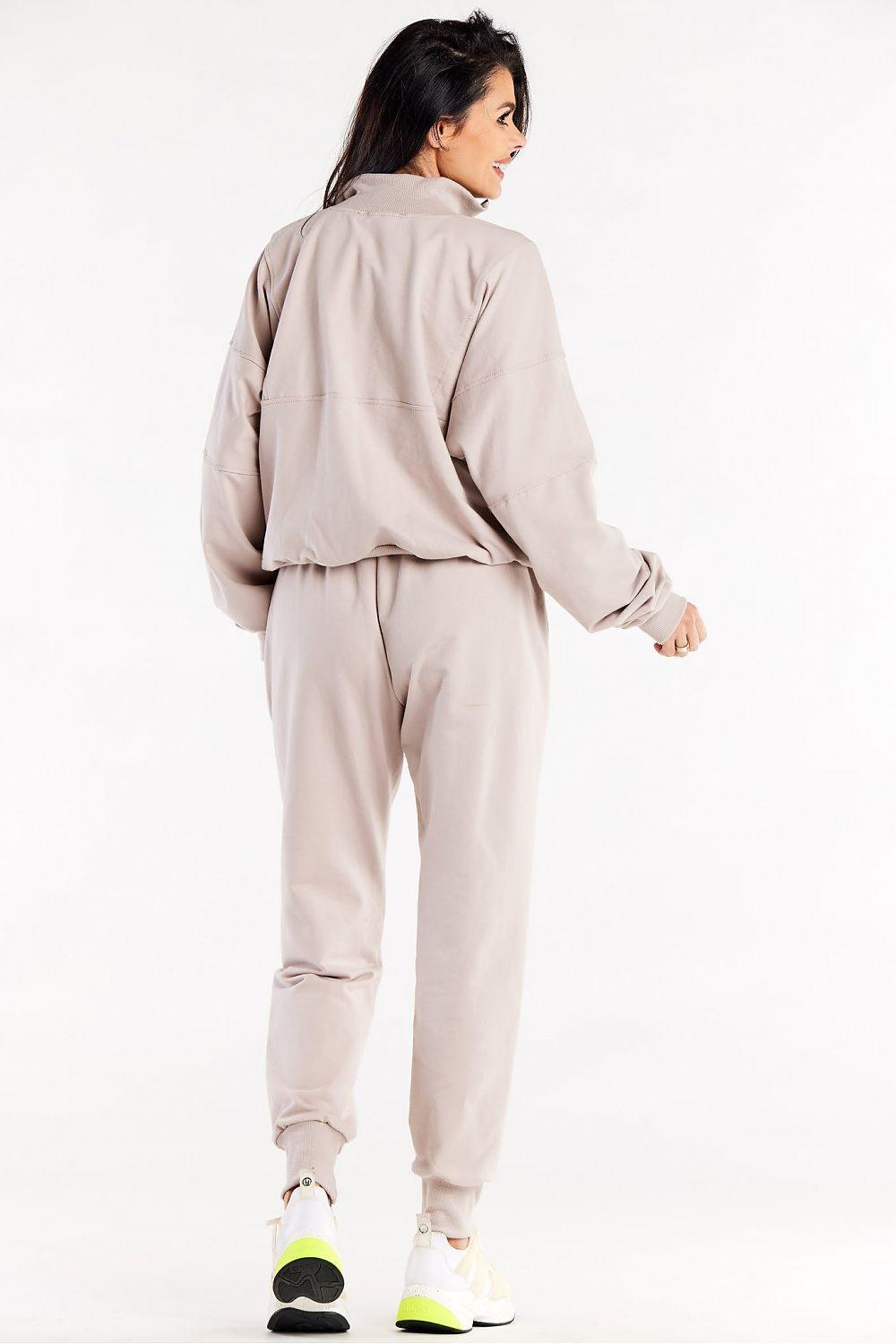 Beige tracksuit trousers, back view, drawstring waist and gathered ankle cuffs