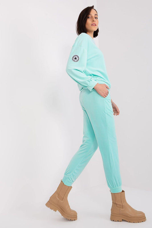 Turquoise two-piece set with circular sleeve patch, long sleeves, drawstring joggers.