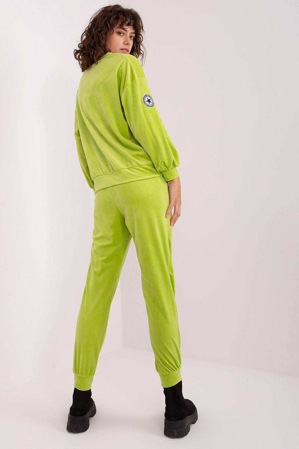 Lime green two-piece jogger set: long-sleeve top and tapered ankle joggers, elastic cuffs.