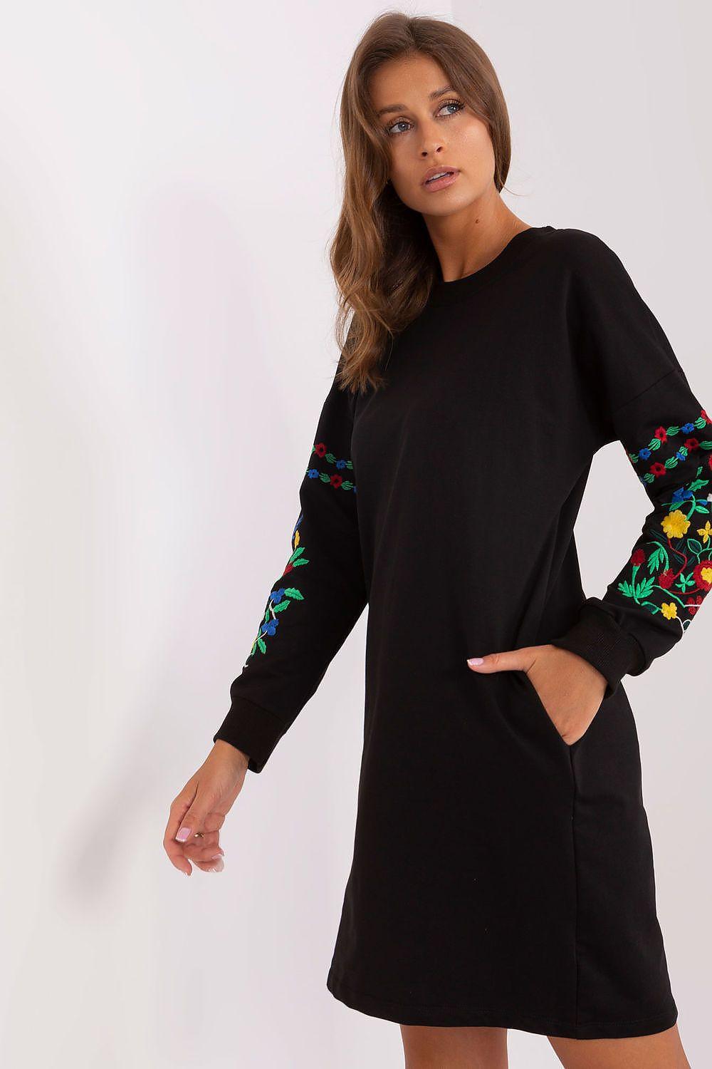 Black daydress with long sleeves featuring colorful floral embroidery on cuffs