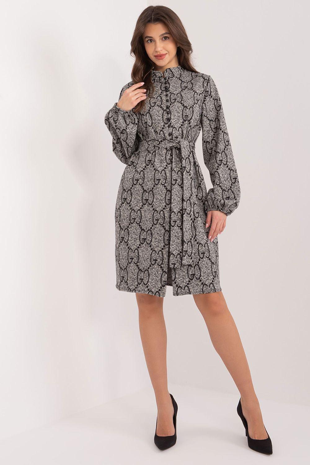 Dark patterned day dress with long sleeves, high neck, and fitted cuffs