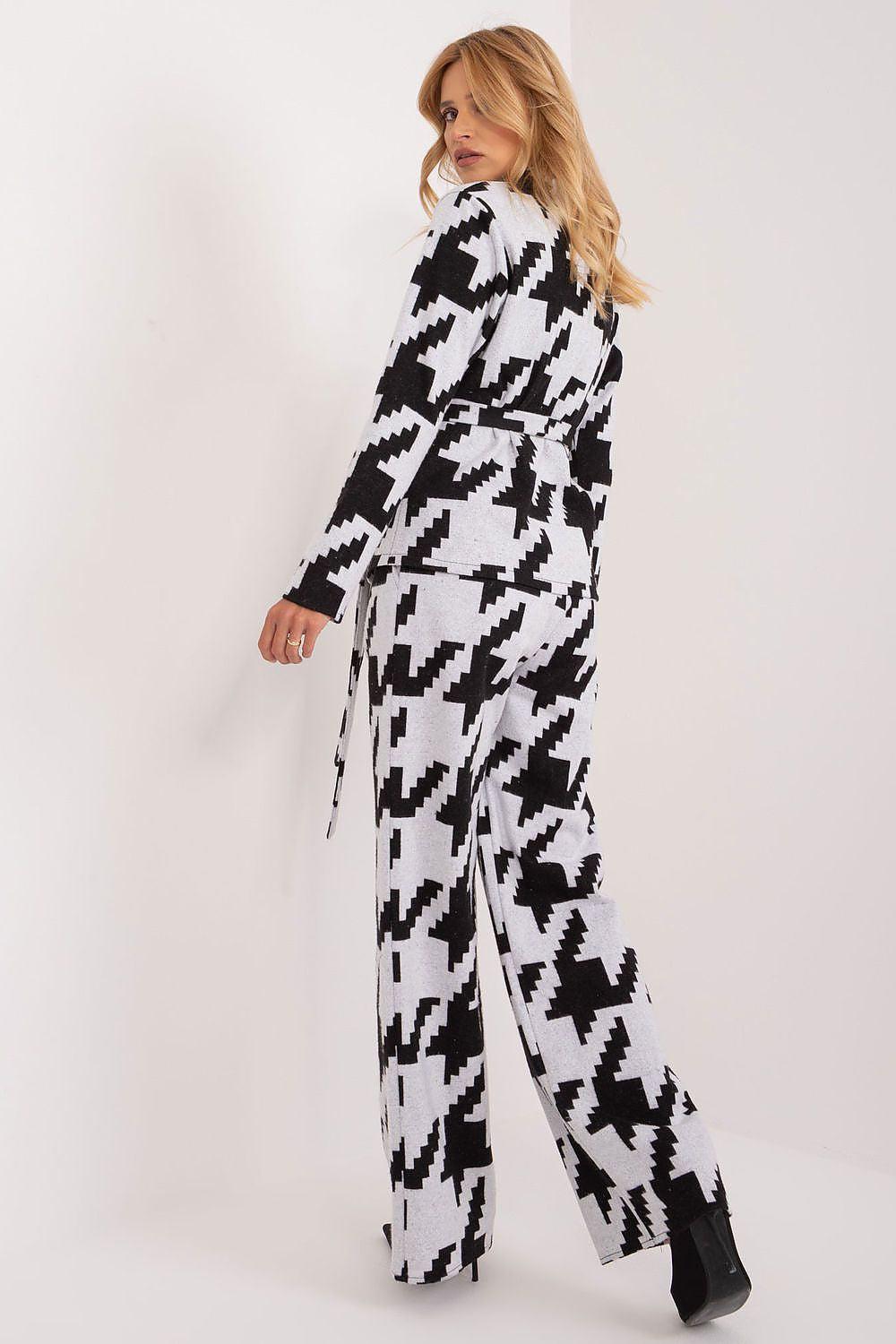 Black-and-white houndstooth patterned wide-leg pants set with long-sleeve top