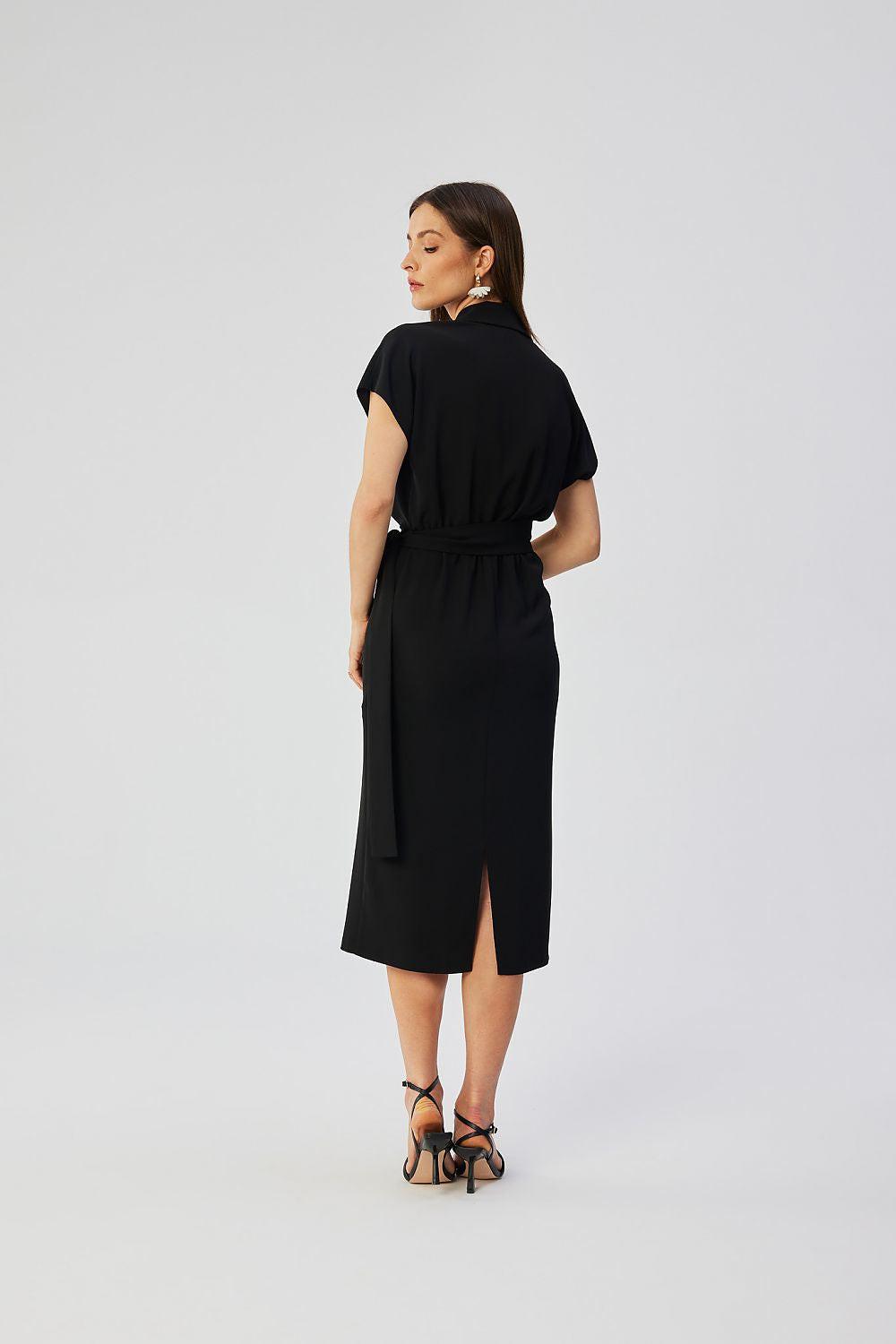 Black wrap day dress, back view, with tied waist belt and midi length.