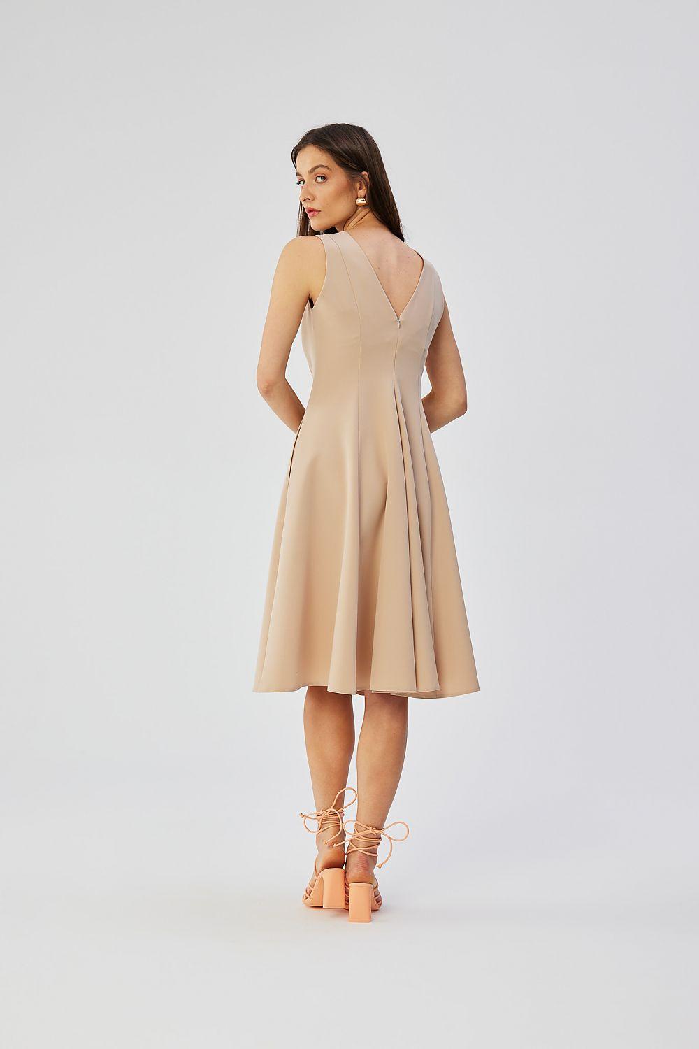 Beige sleeveless daydress with deep V back and pleated skirt