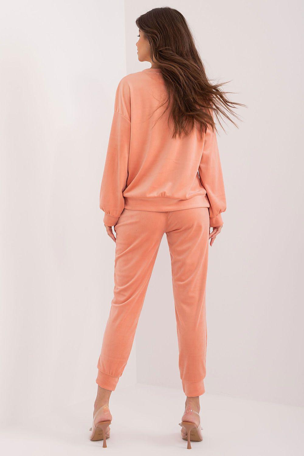 Women's peach sweatshirt and jogger set, back view with tapered joggers