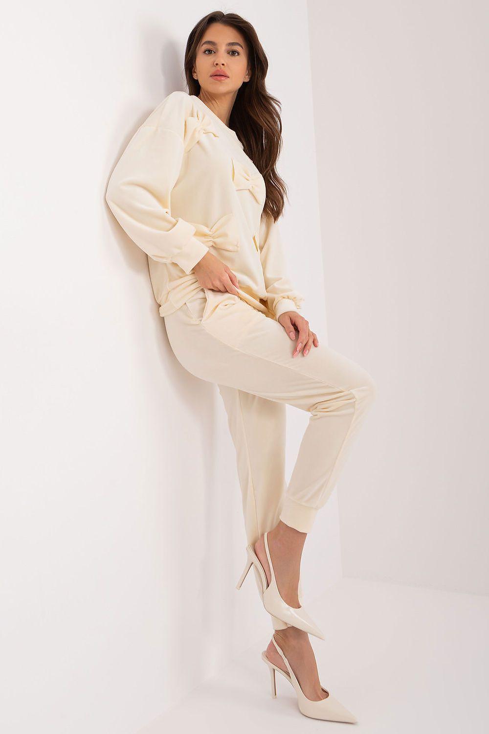 Beige two-piece pajama set with long sleeves and tapered ankle pants, side view