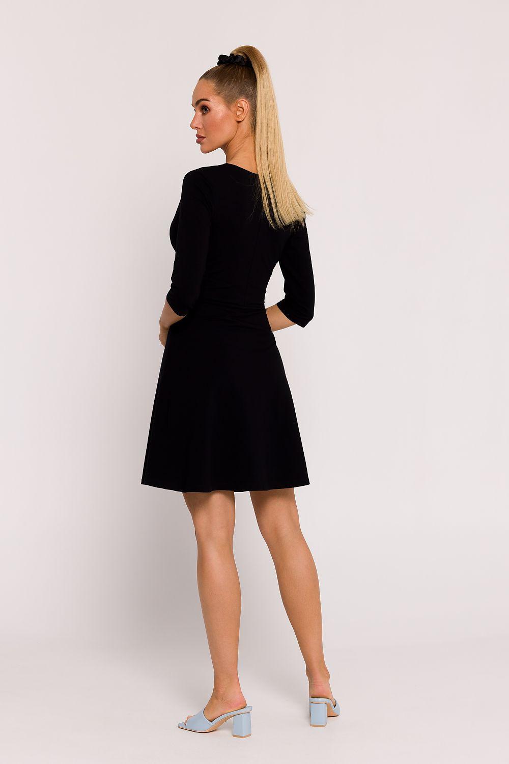 Black daydress with long sleeves and flared skirt, fitted waist