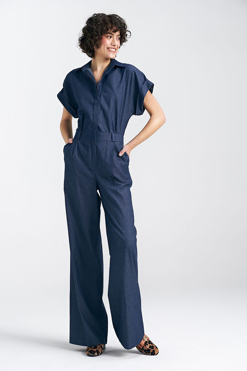 Dark blue denim jumpsuit with short sleeves, V-neck, and wide-leg pants