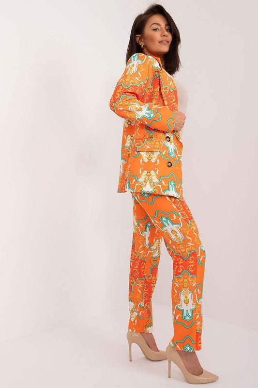 Orange patterned two-piece set, side view: long-sleeve jacket and straight trousers