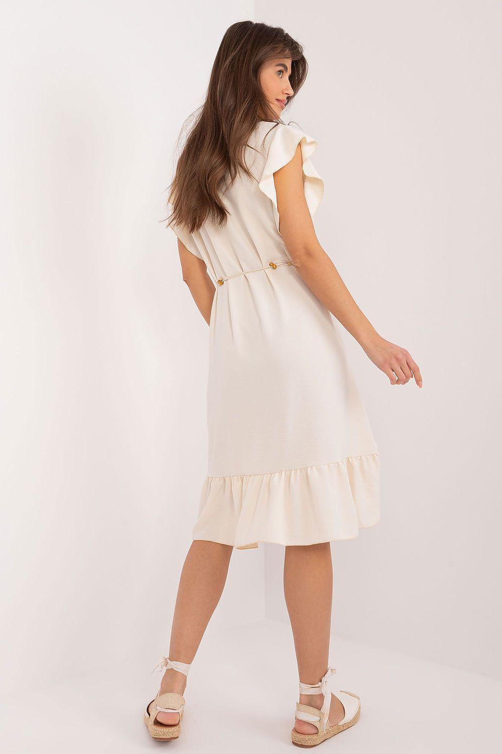 Cream daydress with ruffle cap sleeves and tiered skirt, cinched by a waist belt.