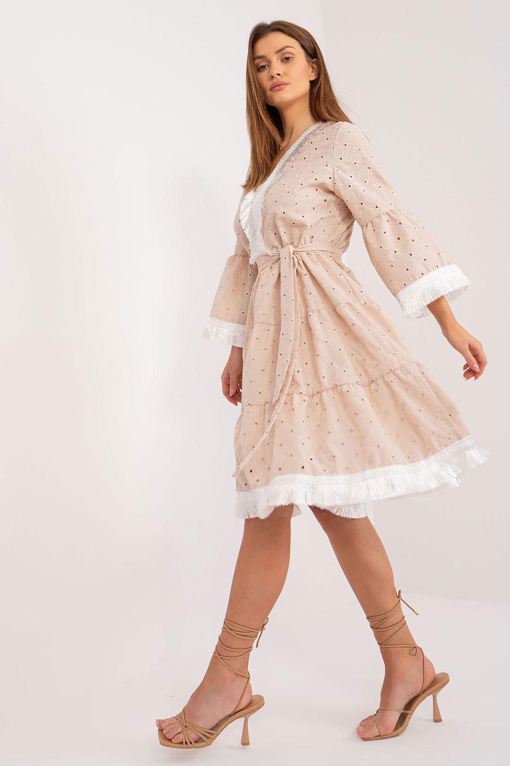 Beige daydress with V-neck, long sleeves, waist tie belt, scattered dot pattern and lace hem