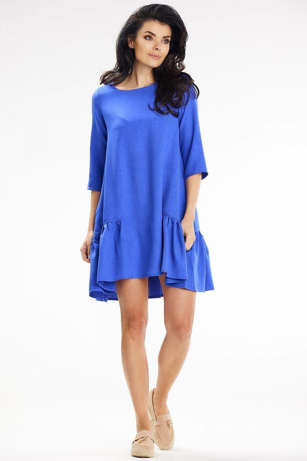 Blue daydress with 3/4 sleeves, scoop neck, and layered hem, above-knee length.