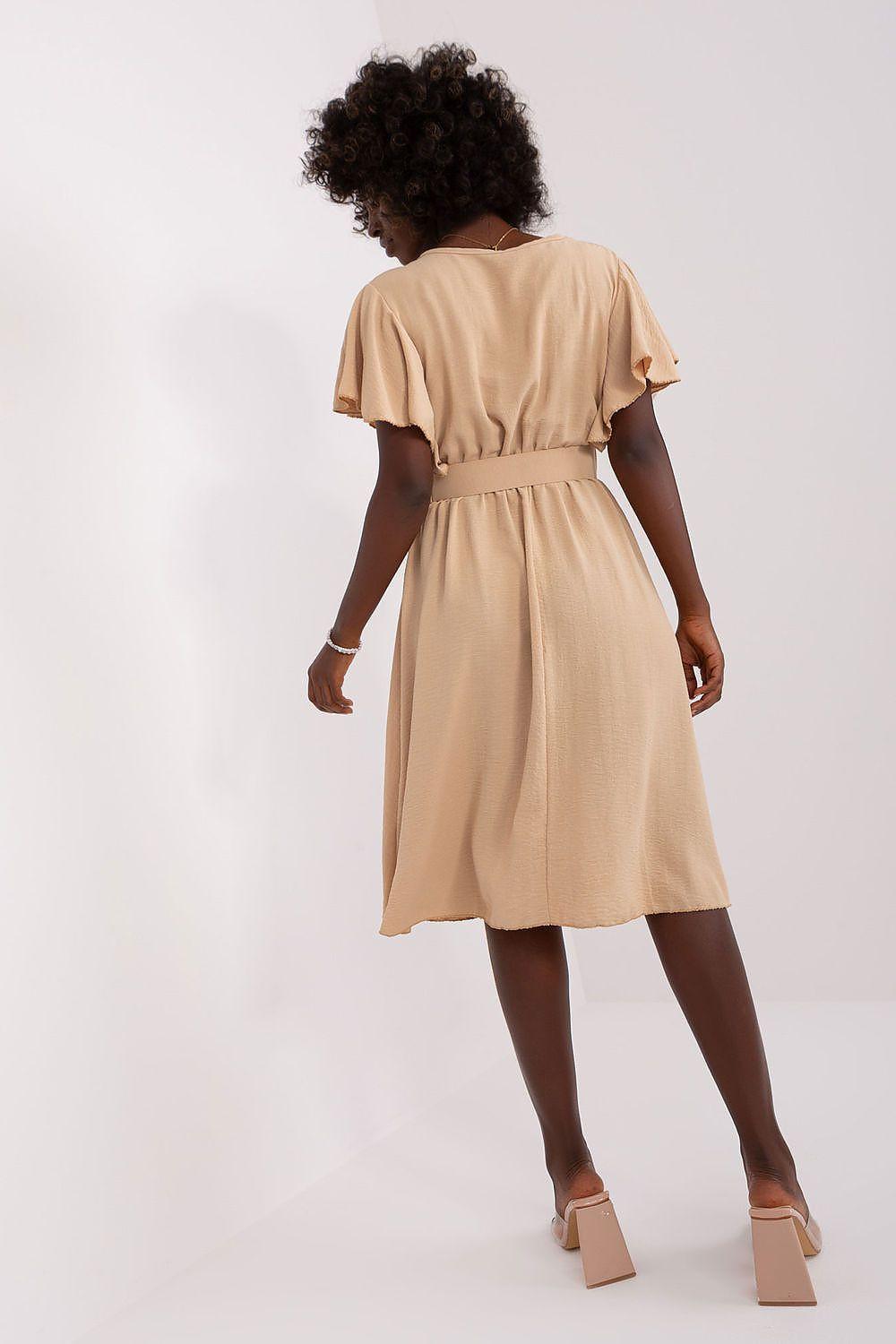 Beige daydress from back view, gathered waist and flared skirt with short sleeves.