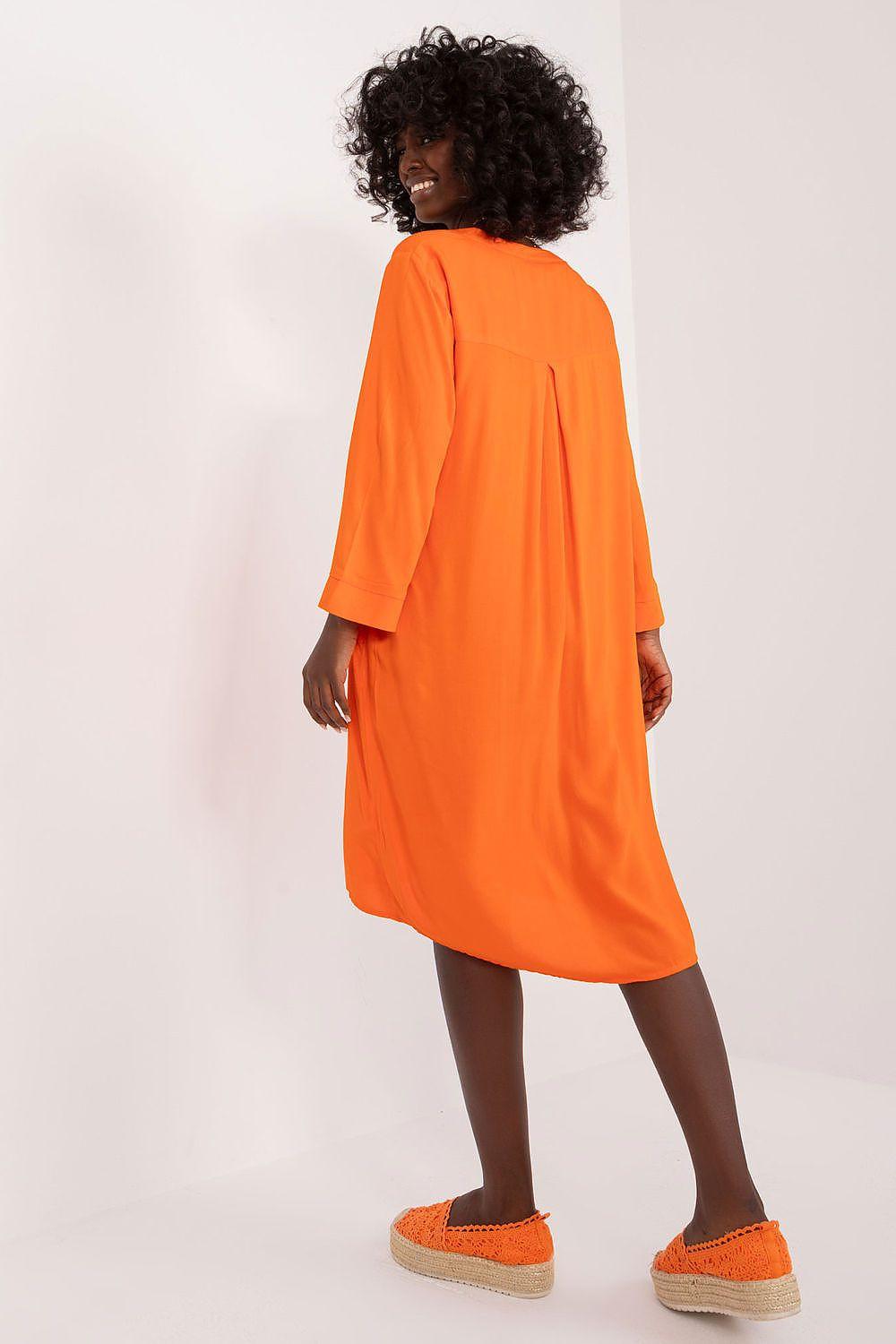 Orange daydress with relaxed fit, three-quarter sleeves, and curved hem