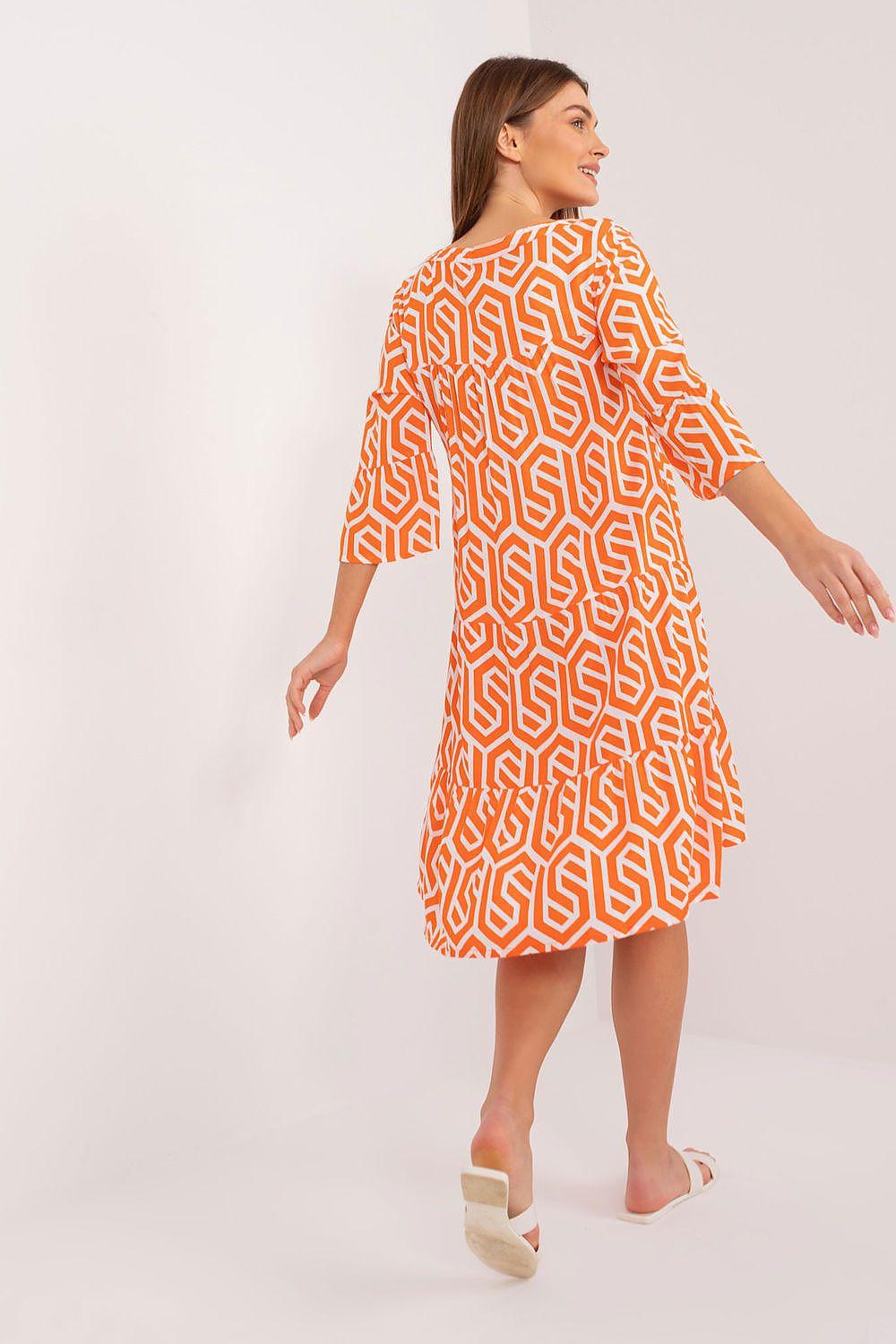 Orange patterned day dress with long sleeves and A-line flared skirt, back view