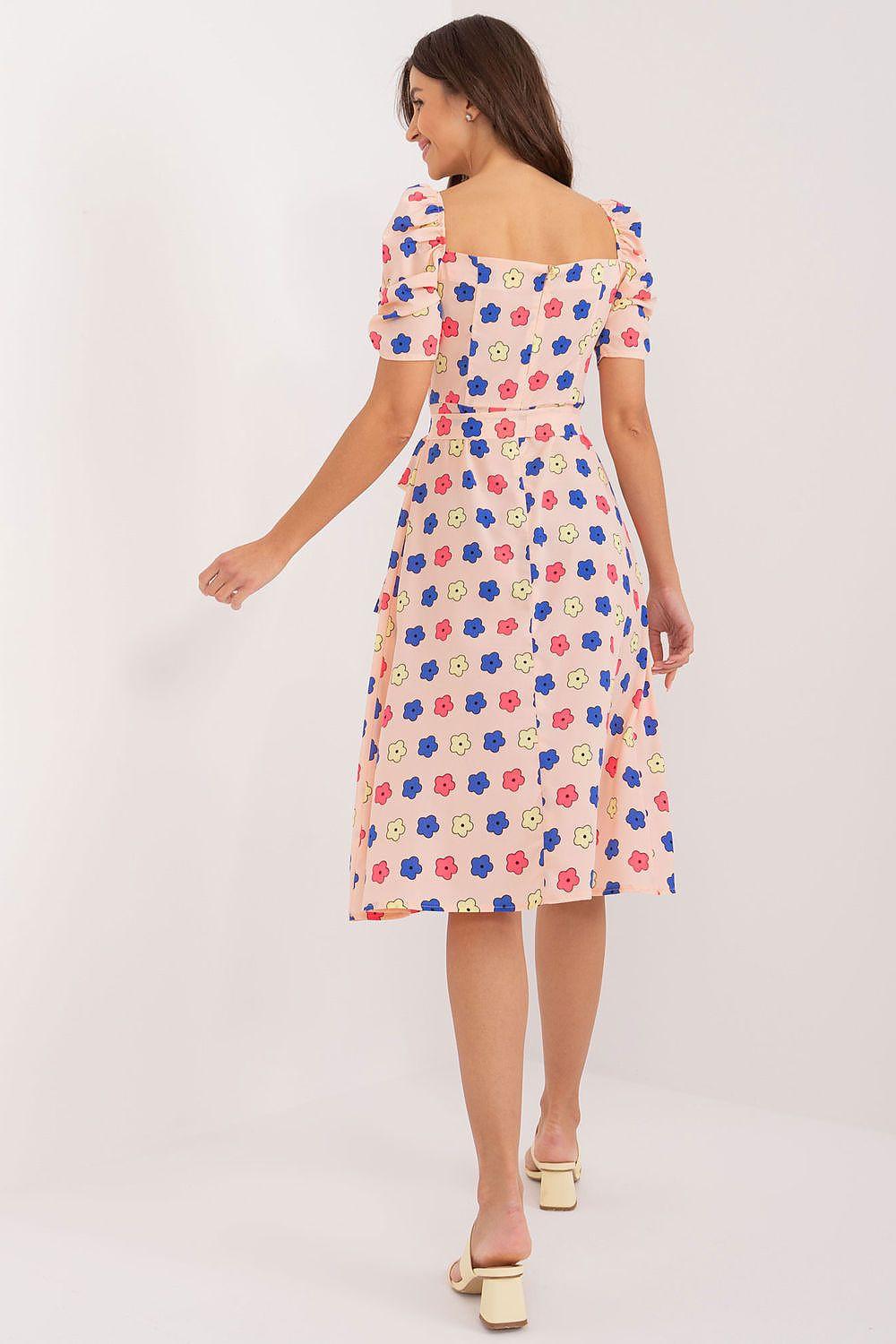 Back view of a white daydress with colorful flower print and puff sleeves