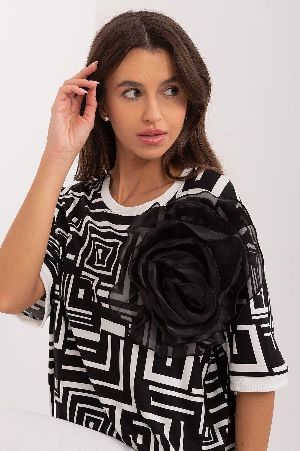 Geometric print blouse with black rose applique and round neckline, short sleeves
