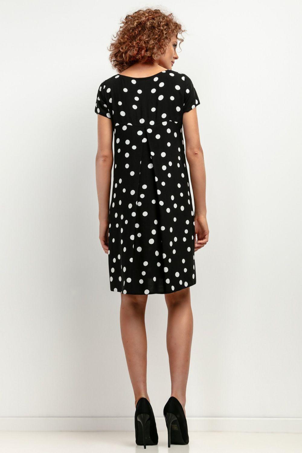 Polka-dot daydress back view with cap sleeves, knee length, black with white dots.
