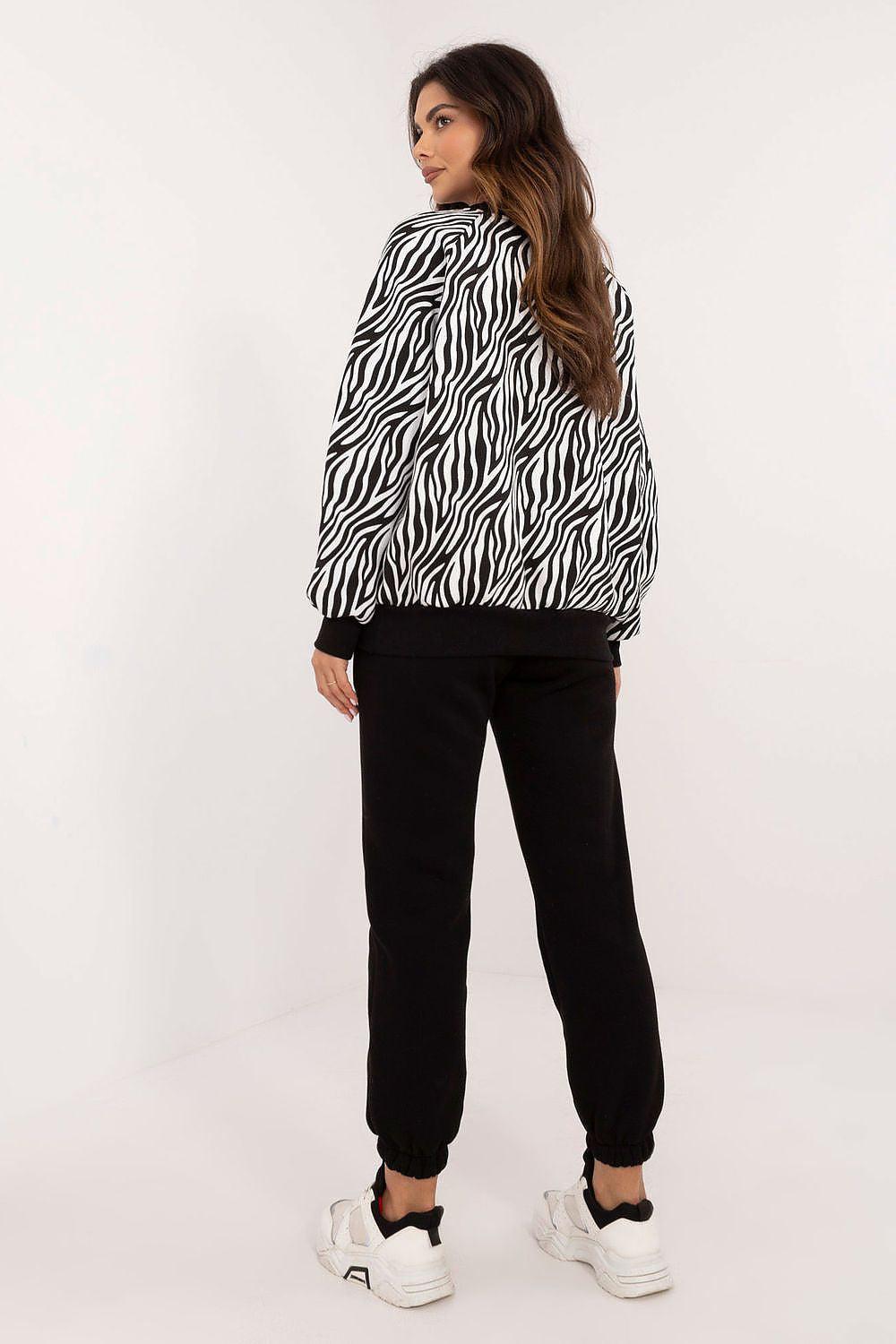 Zebra-print hoodie paired with black jogger pants, ankle-length tapered fit
