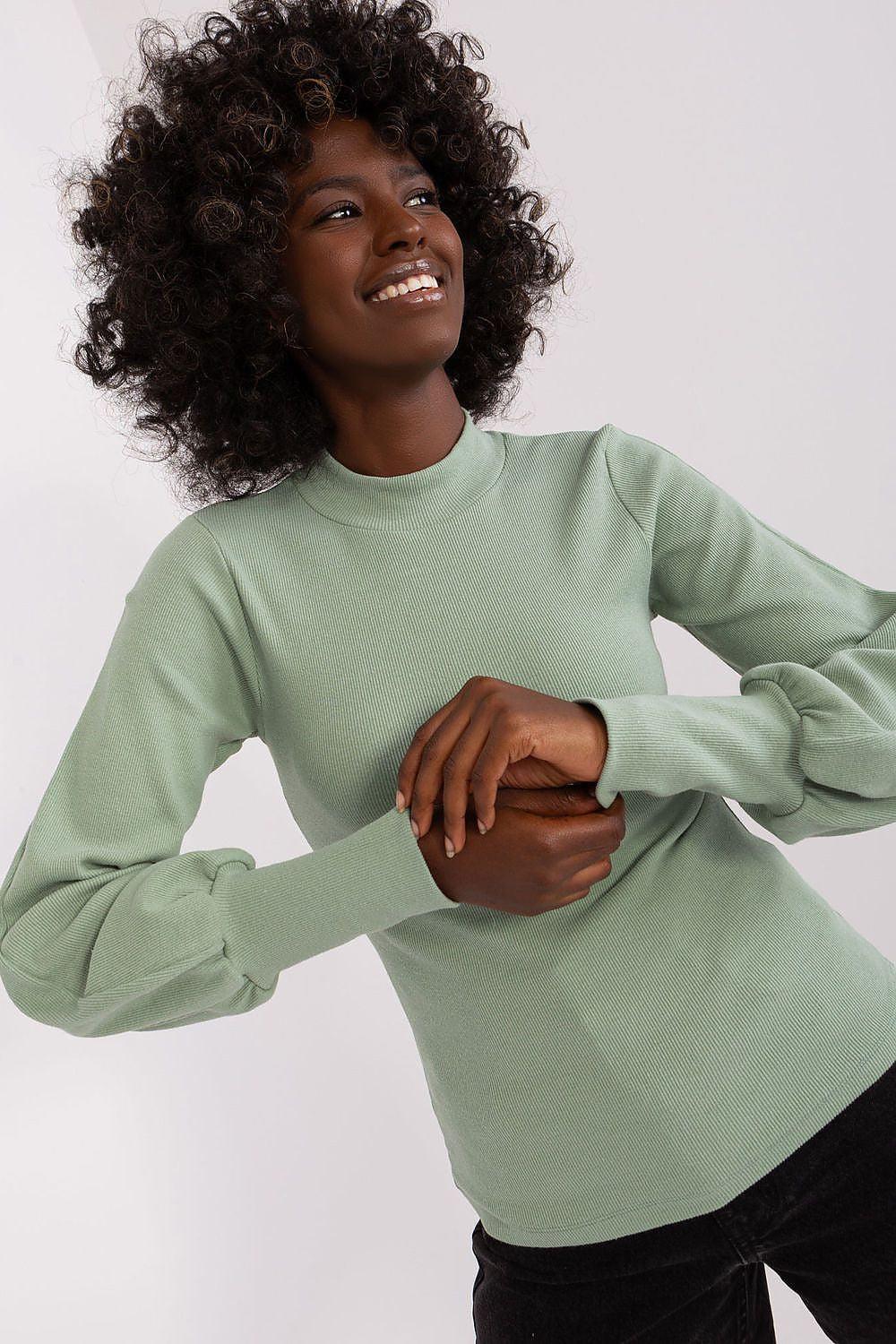 Sage green long-sleeve ribbed crew-neck blouse, close-up of neckline
