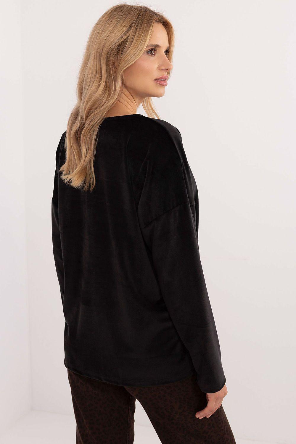Black velour blouse back view with long sleeves and curved hem