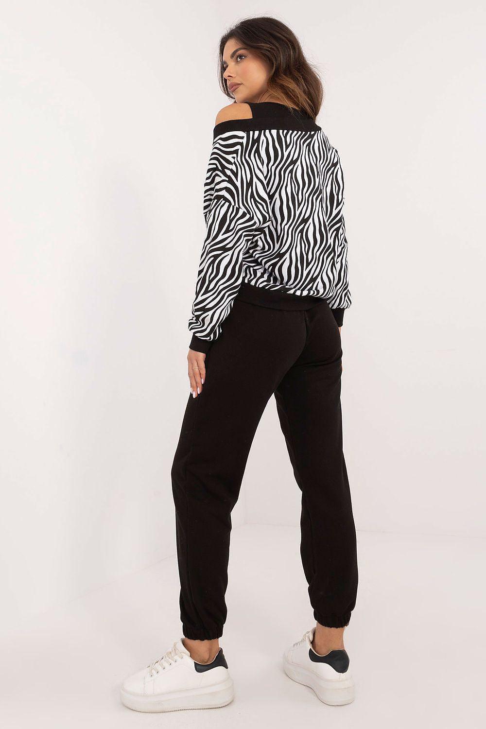 Zebra-print sweatshirt and black jogger pants set, side view, tapered legs