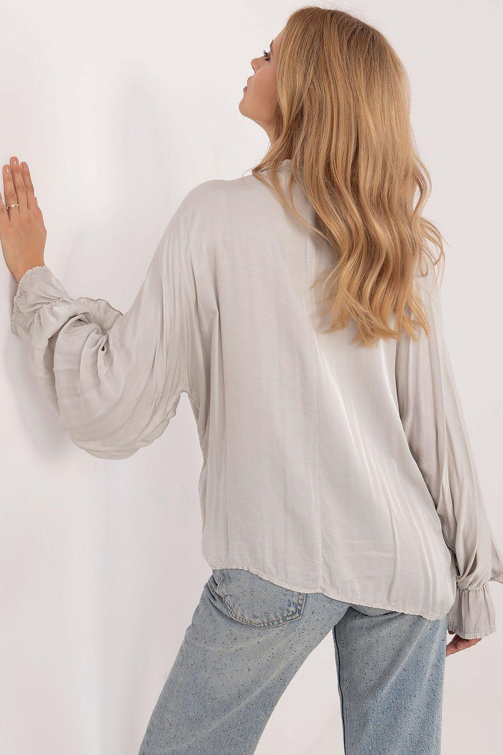 White long sleeve shirt with gathered cuffs and tie detail at sleeves