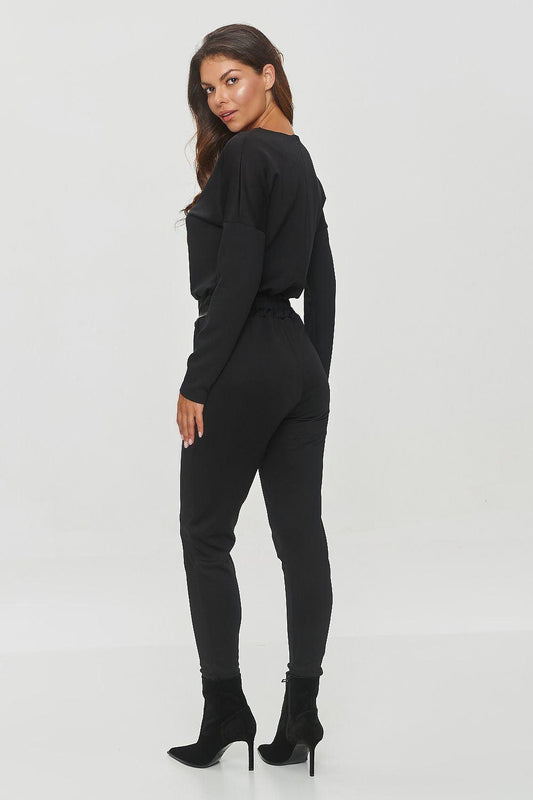 Women's black V-neck top and slim pants set, side view
