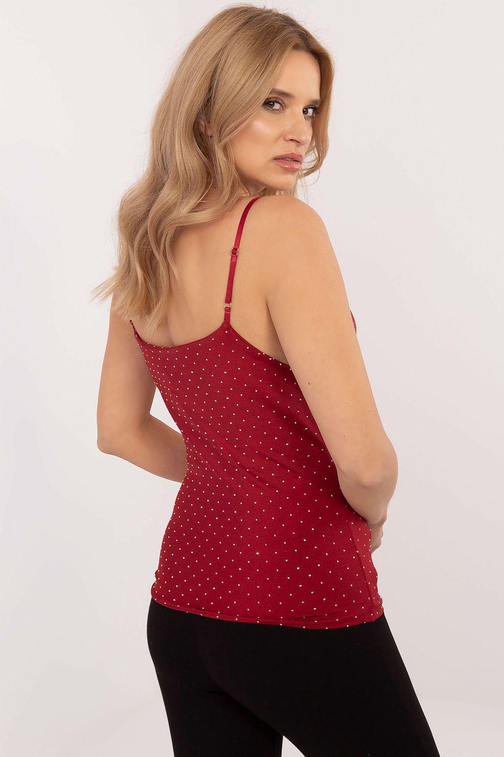 Red camisole top with thin straps and tiny speckle print, open back.