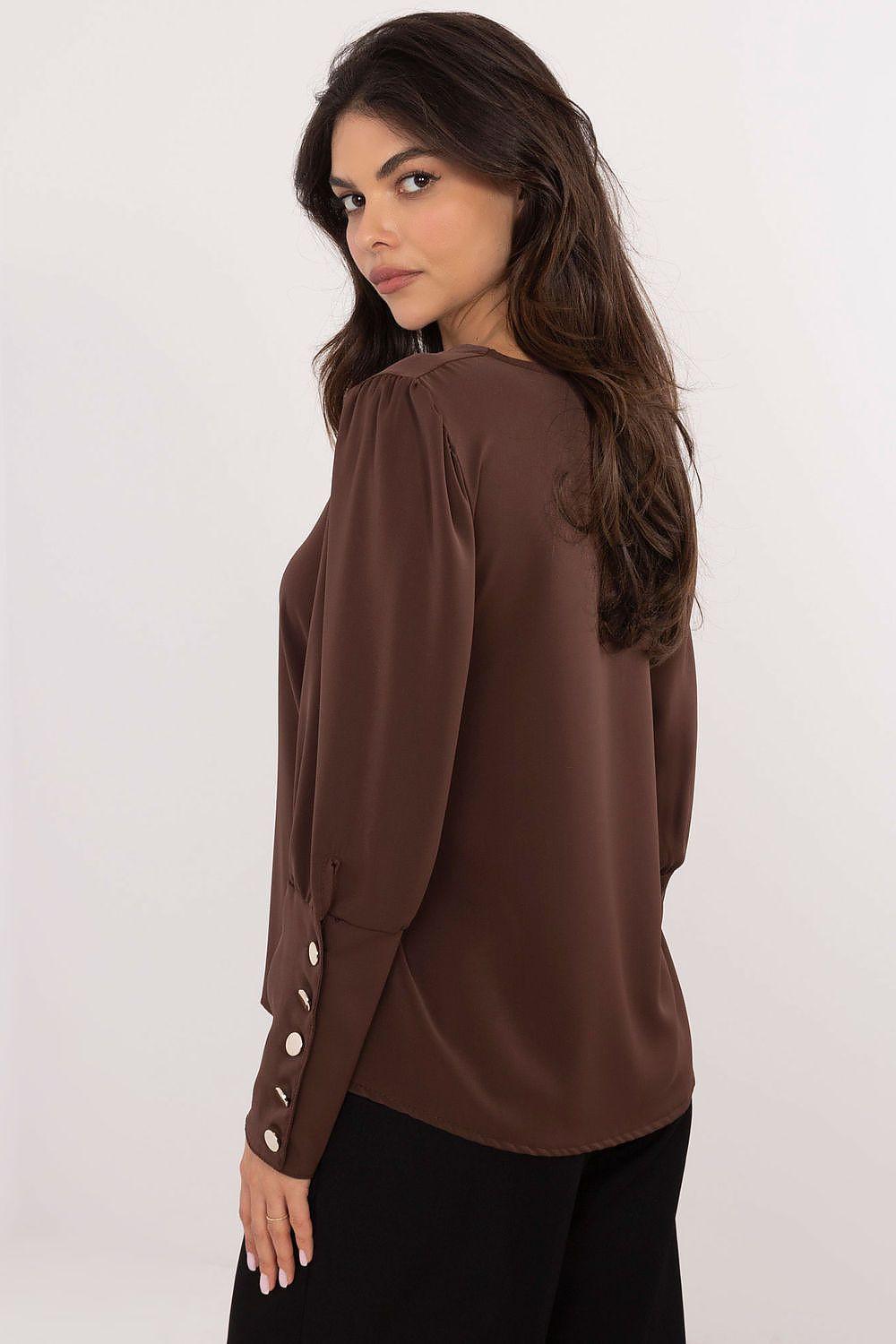Brown V-neck blouse with gathered sleeve detail and button cuff, side view
