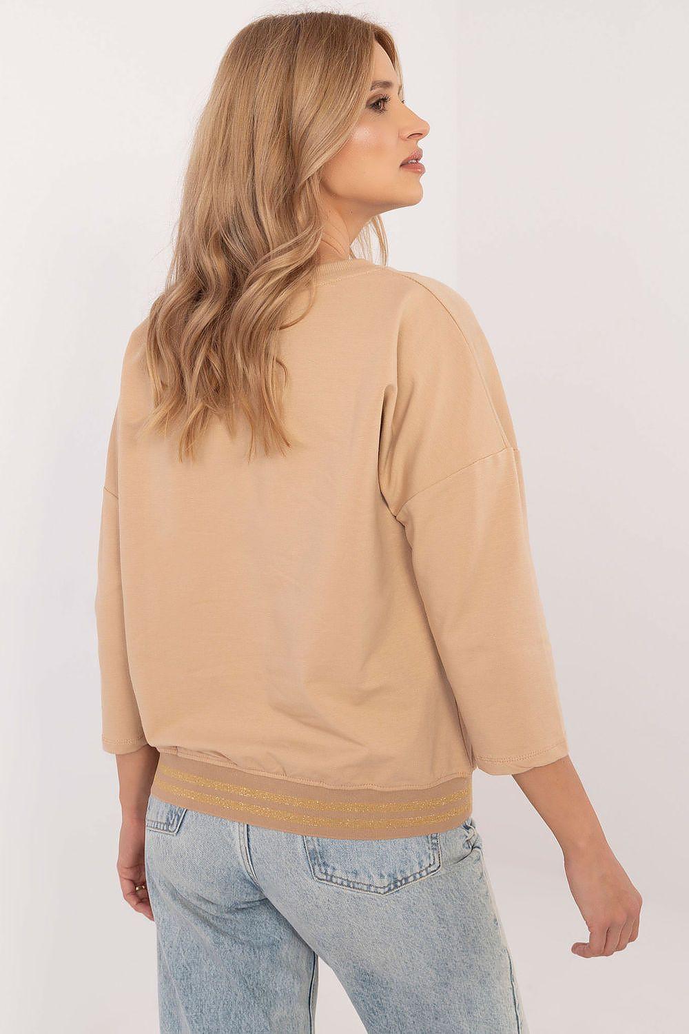 Beige/tan blouse with 3/4 sleeves and striped hem band, back view
