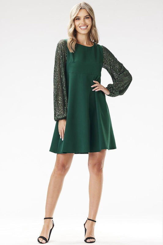 Green evening dress with long textured sequin sleeves and short flared hem