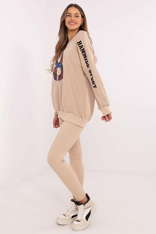 Beige sweatshirt and leggings set, side view with graphic print and cuffed sleeves