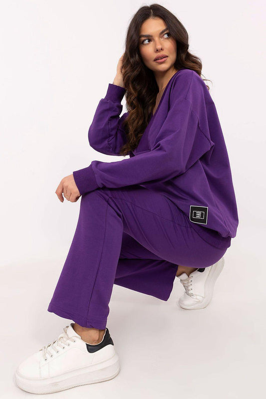 Violet two-piece tracksuit set, dropped-shoulder pullover and cuffed straight pants.