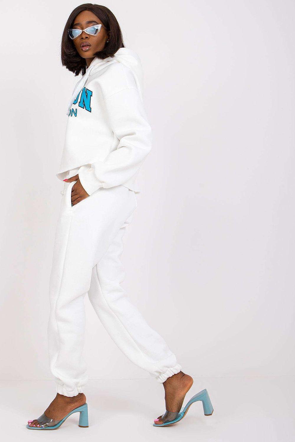 White hoodie and jogger tracksuit set with logo on sleeve and ankle-cuff joggers