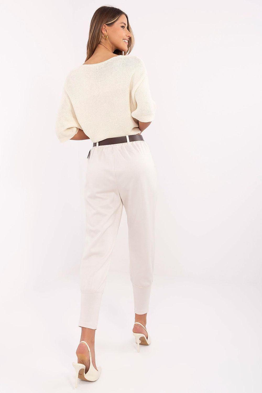 Tracksuit trousers, beige, back view, drawstring waist and tapered ankle cuffs.