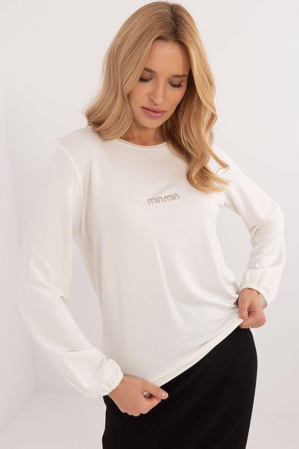 White long-sleeve blouse with crew neck and subtle chest logo