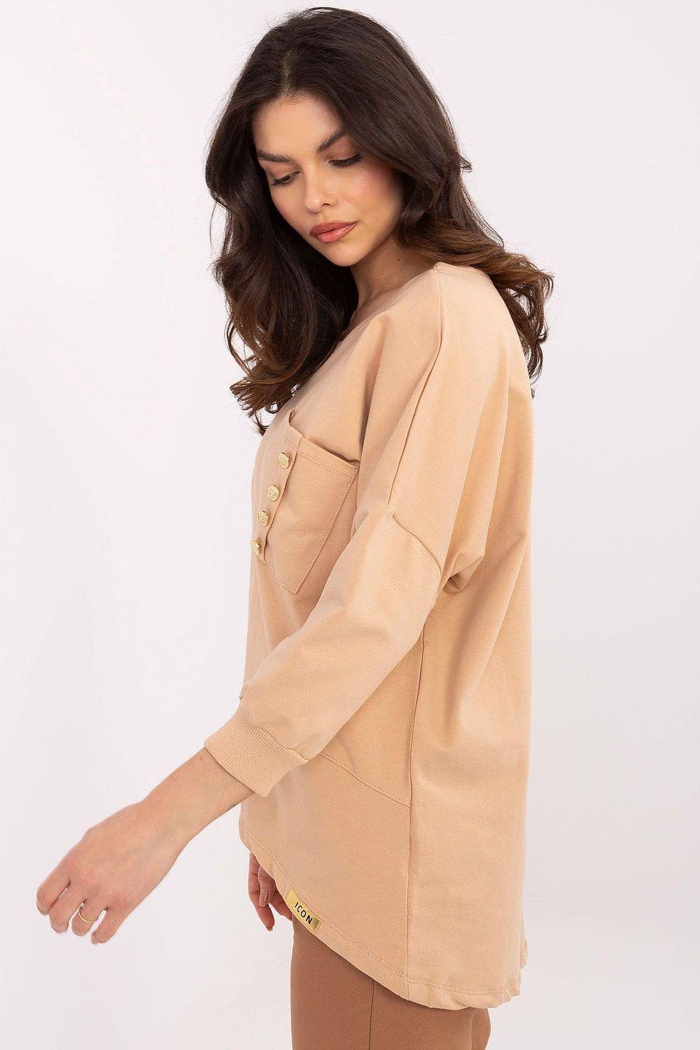 Tan blouse with long sleeves and round neck, side profile