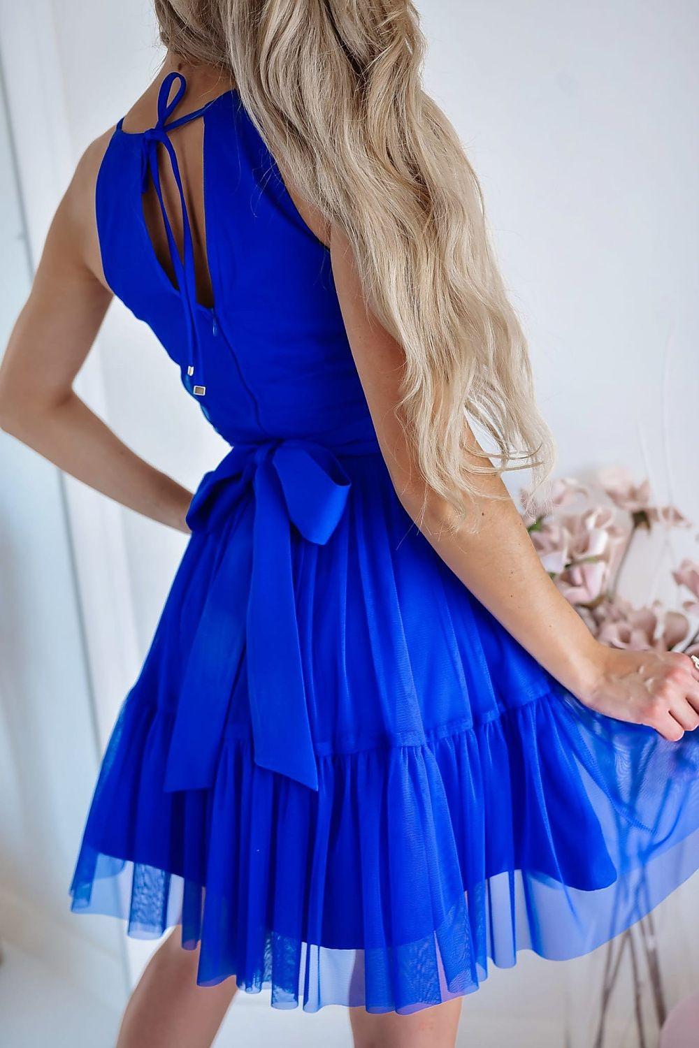 Blue halter evening dress close-up with tied neckline bow and tiered tulle skirt