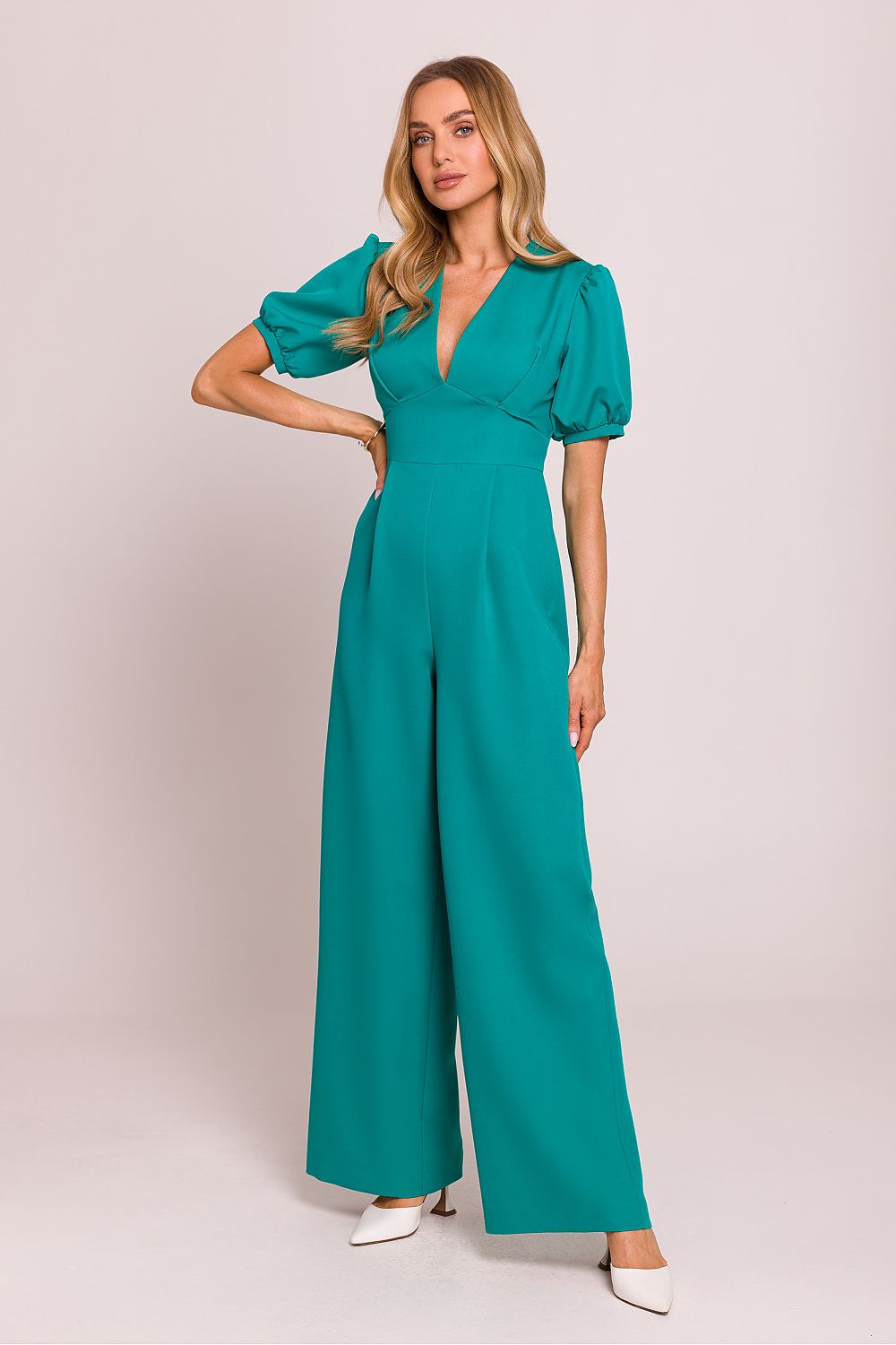 Green feminine jumpsuit with V-neck, puff sleeves, and wide-leg trousers.
