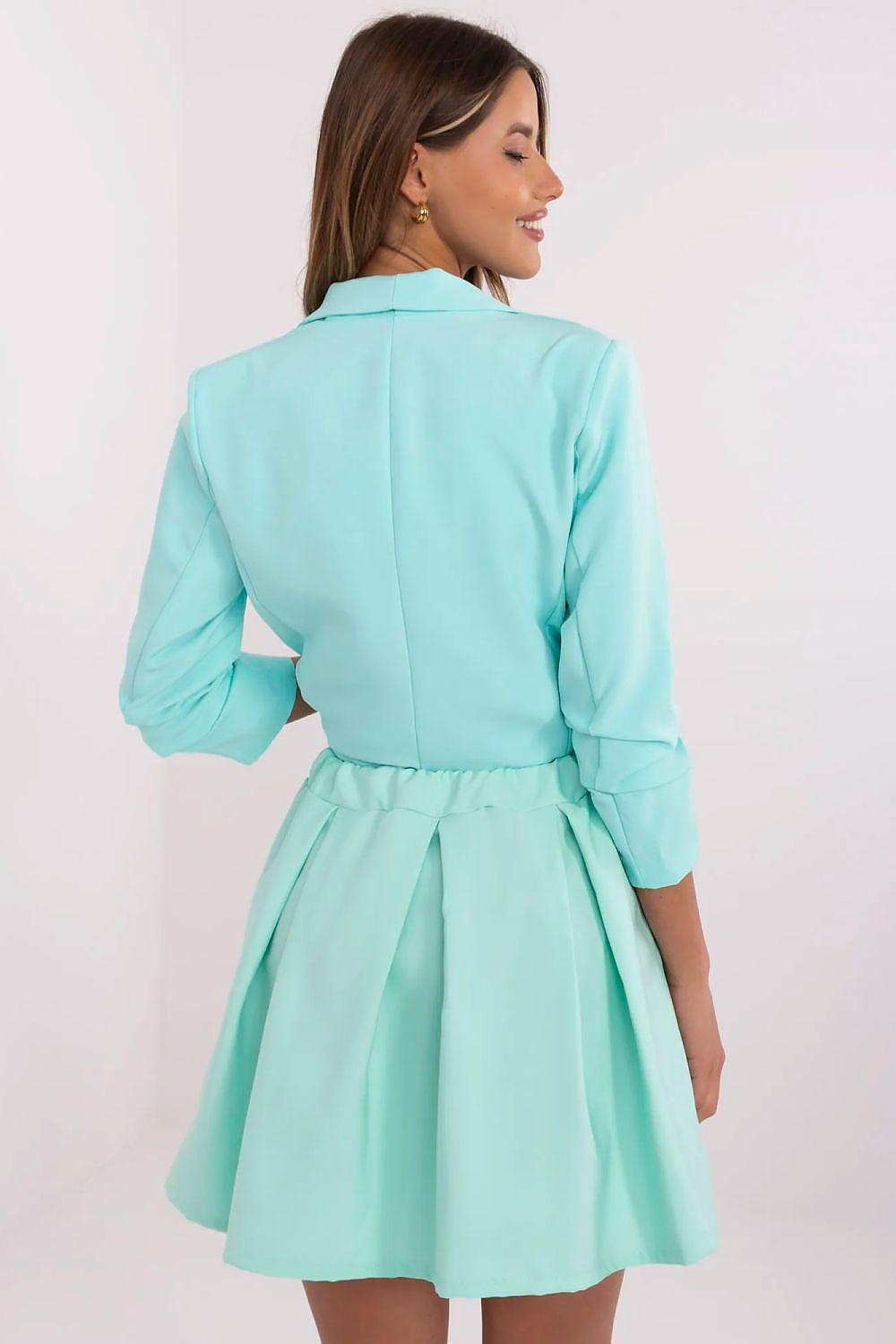 Teal pleated mini skirt with elastic back waist and built-in shorts.
