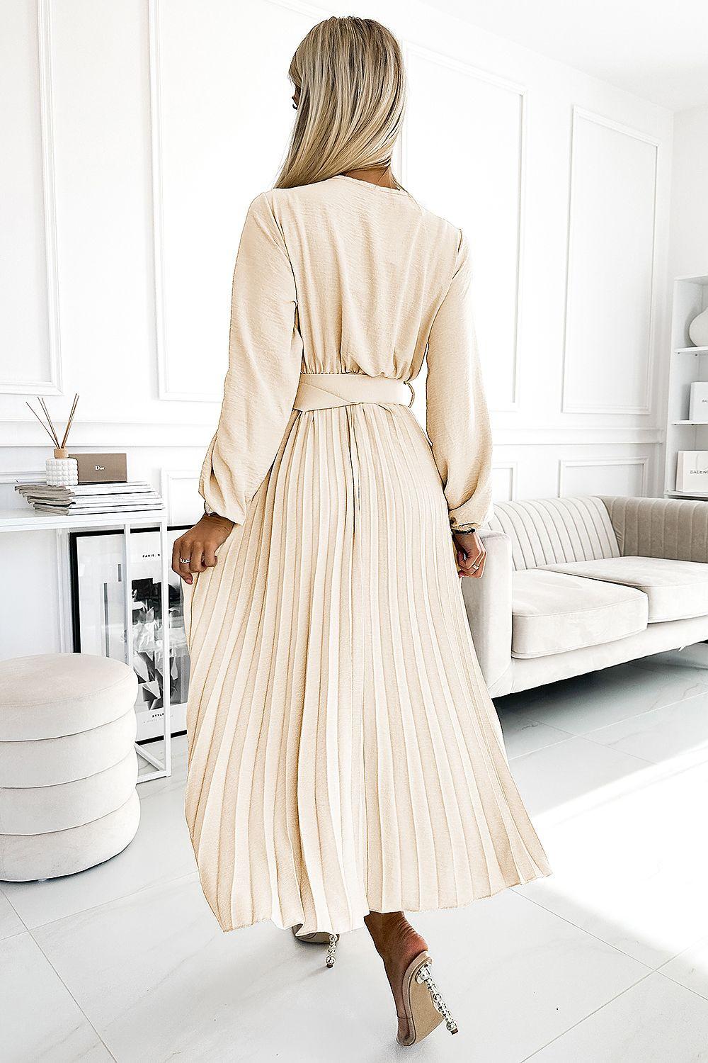 Cream pleated cocktail dress, back view, long sleeves and belted waist with pleated skirt