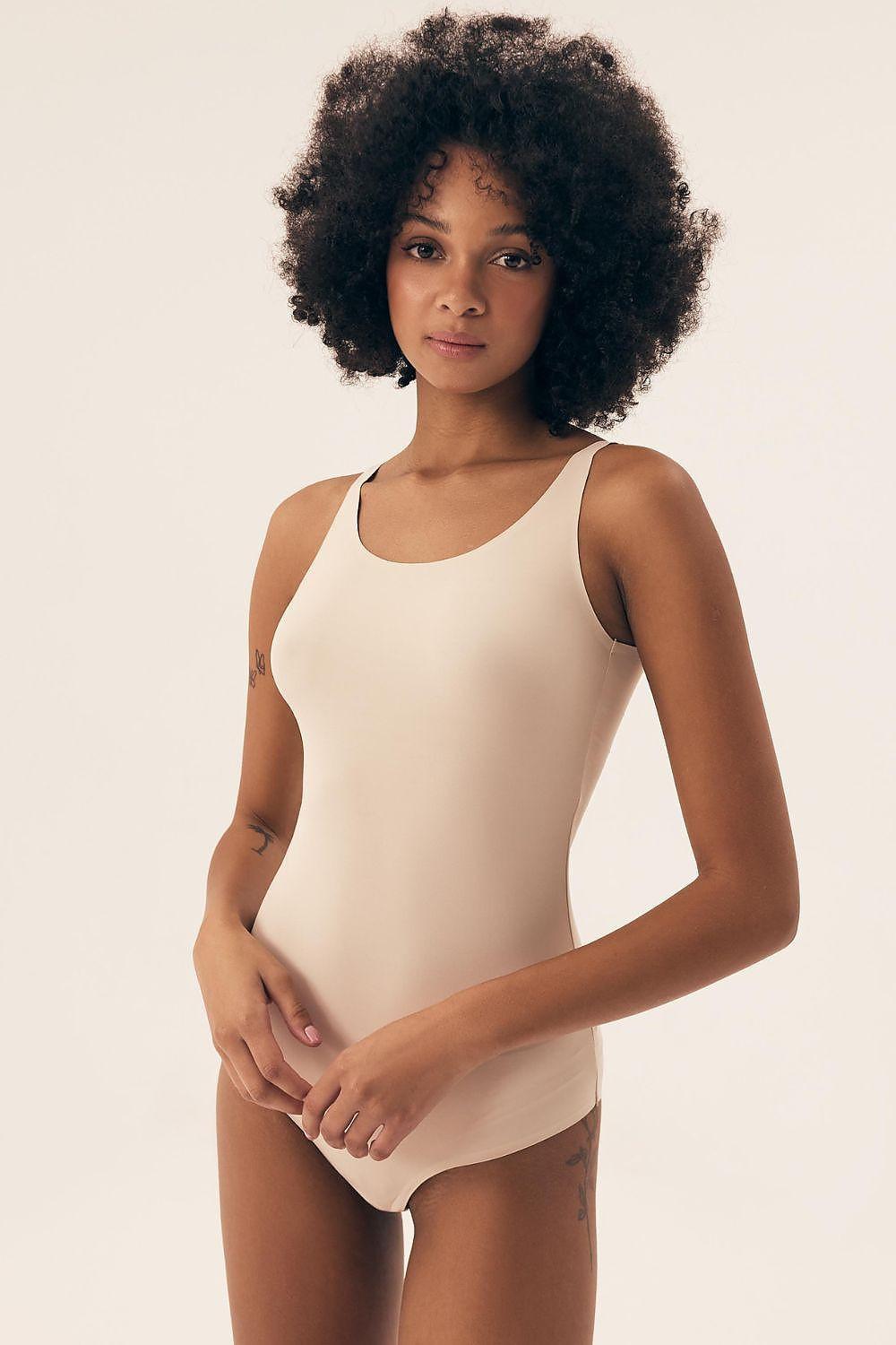Beige seamless shapewear bodysuit with scoop neckline and high-cut legs