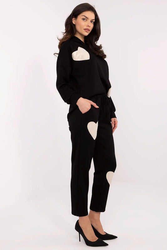 Black two-piece lounge set with heart applique hoodie and tapered jogger pants